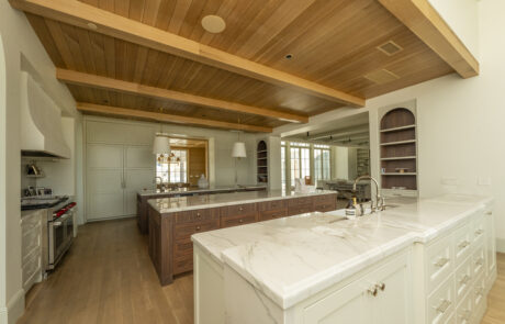 Ceiling beams and ceiling panels create a warm, dramatic look i this kitchen.