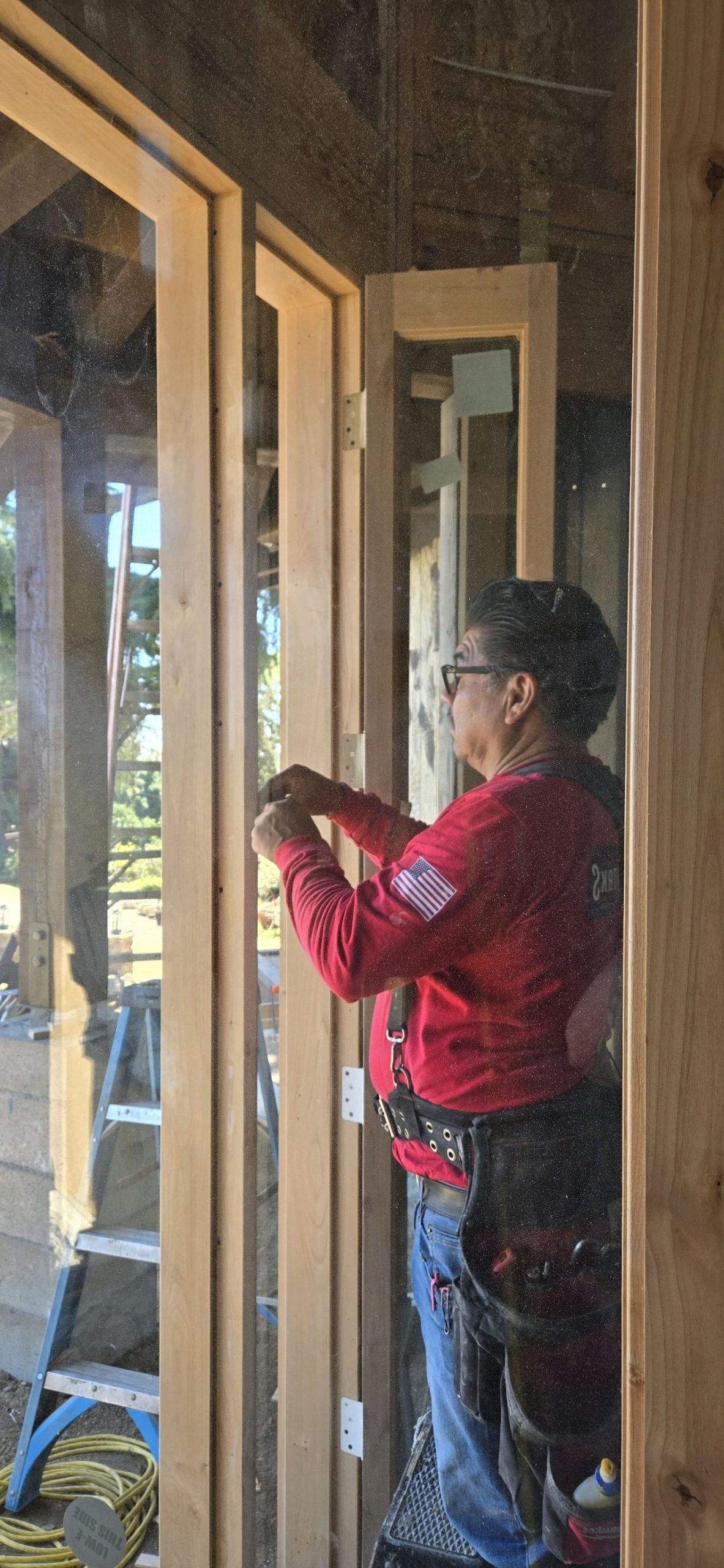 Youngren Tradeworks installer working hard on a closet door installation
