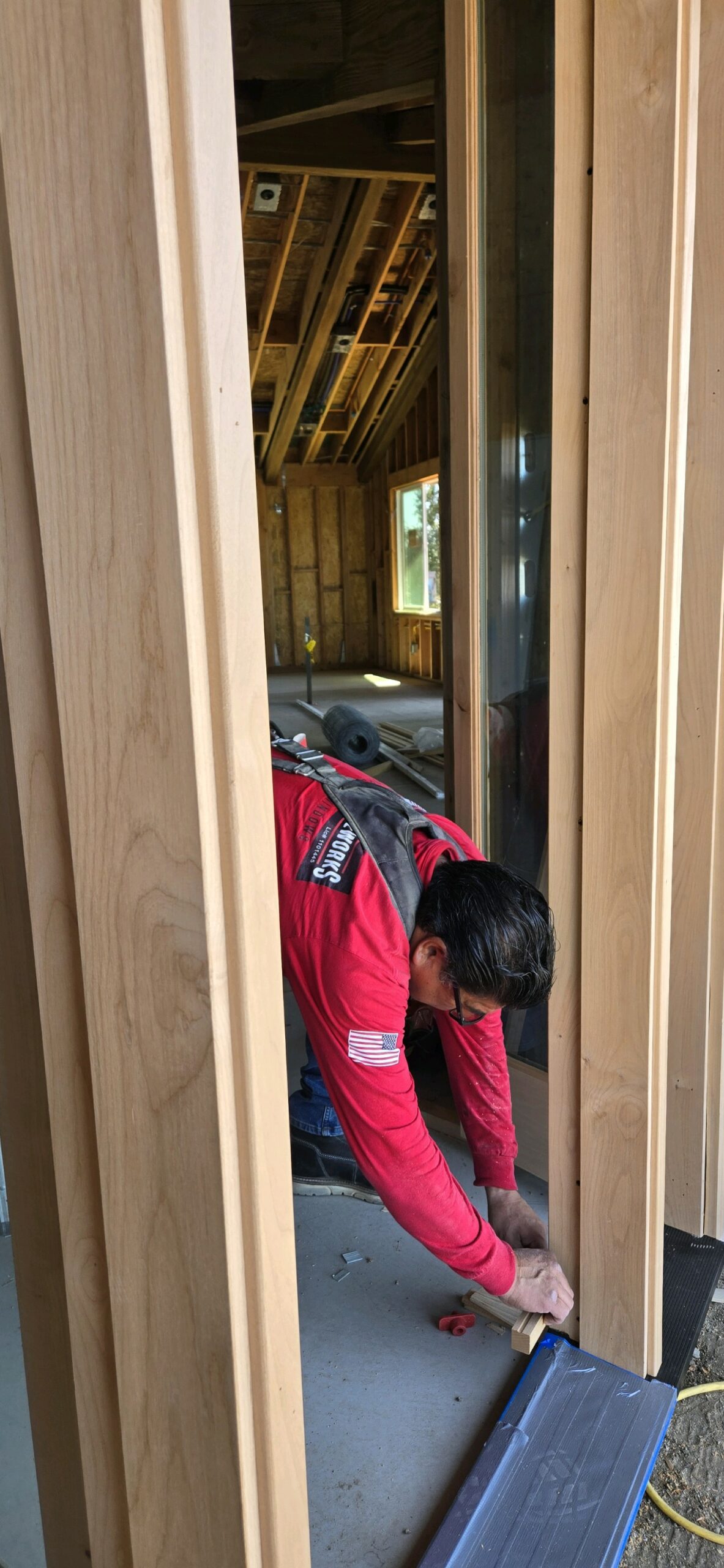 Youngren Tradeworks team member measures molding for a millworks project