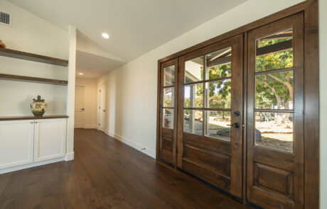 Stunning wood entry doors with window panels installed by Youngren Tradeworks